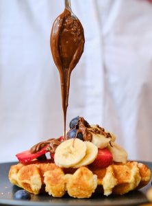 chef pouring chocolate with spoon
