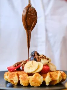 chef pouring chocolate with spoon